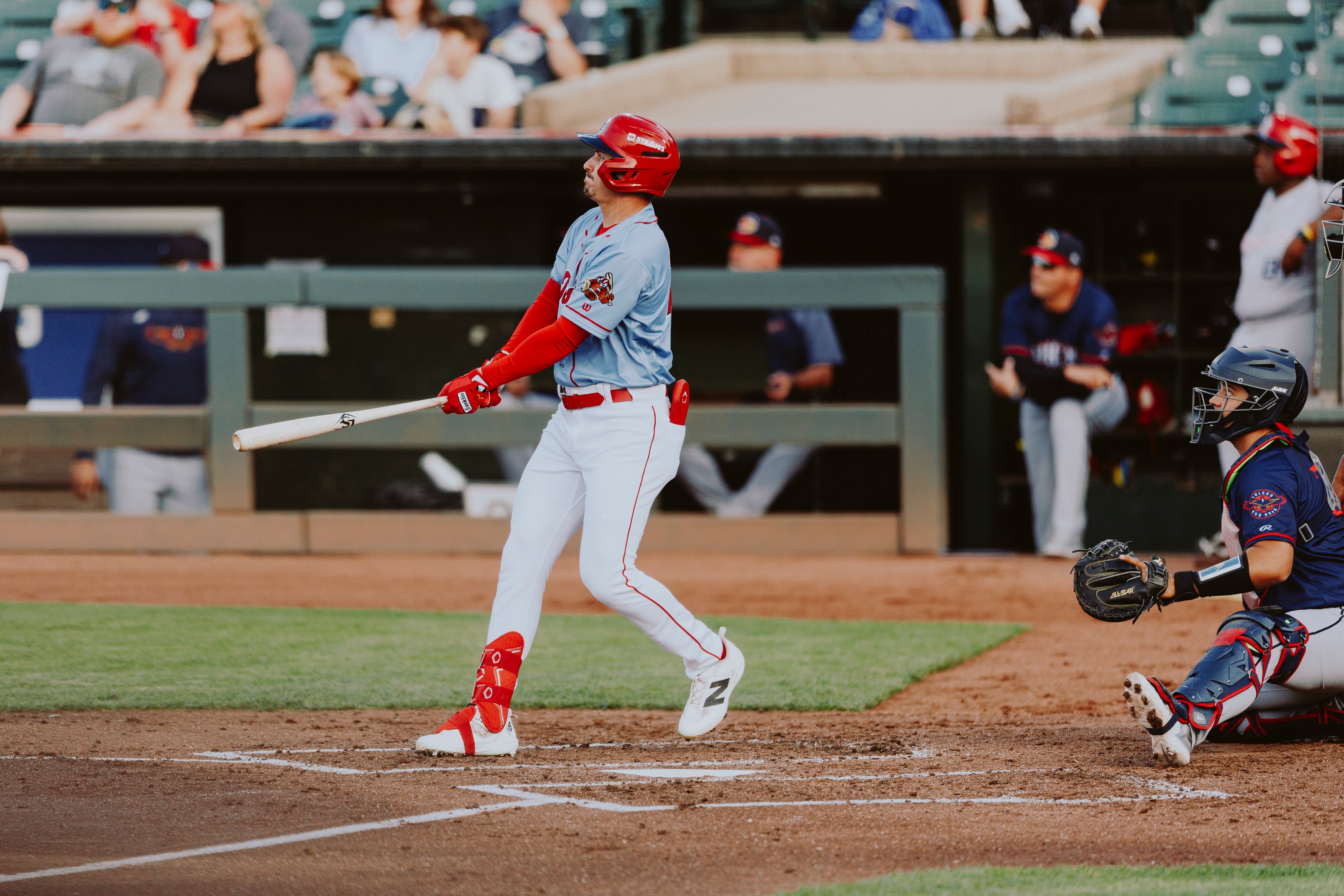 JJ Bleday follows through on a swing in a Louisville Bats uniform, watching the ball leave the bat