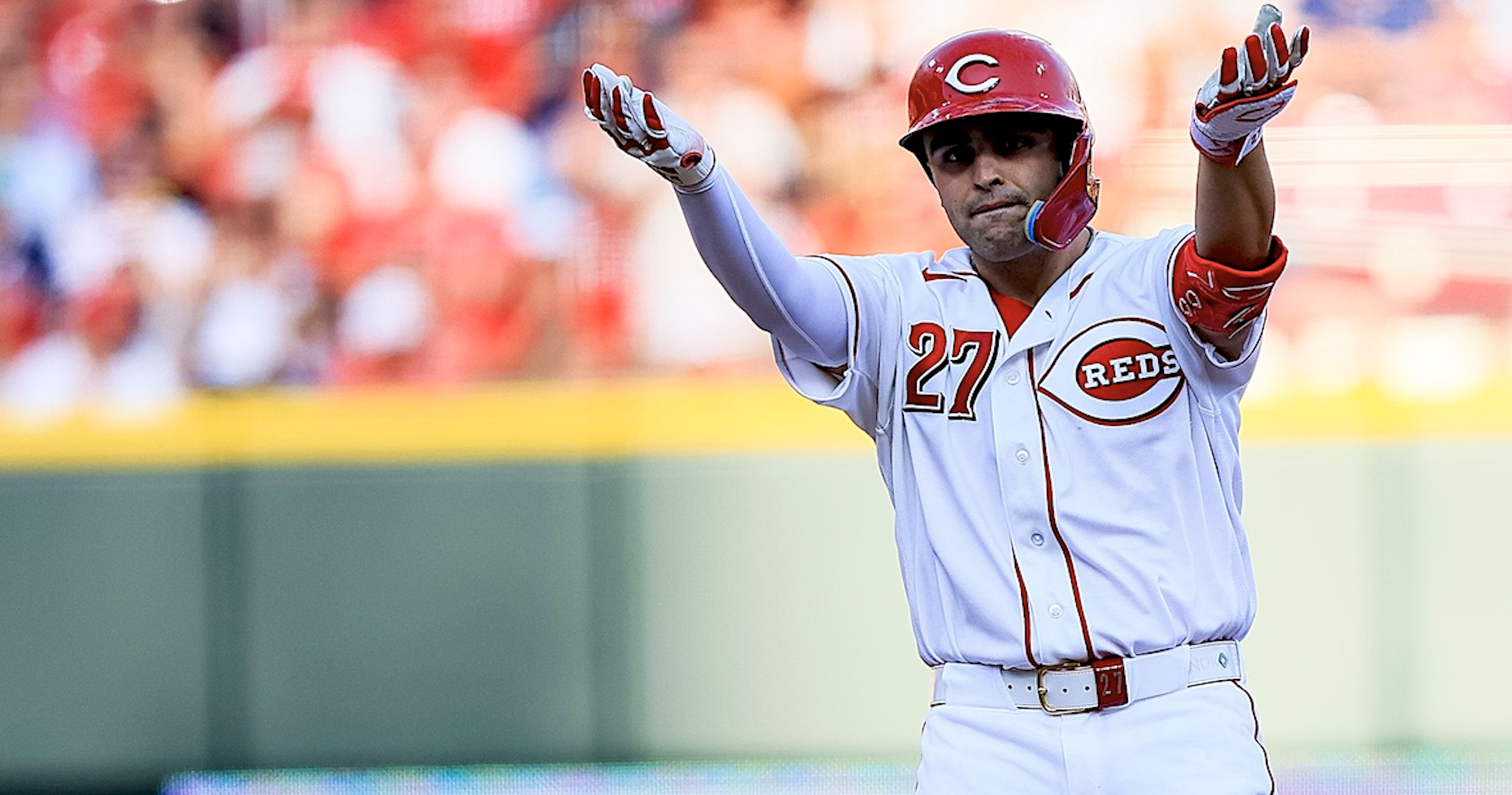 Sal Stewart of the Cincinnati Reds celebrates at second base, arms raised, wearing number 27